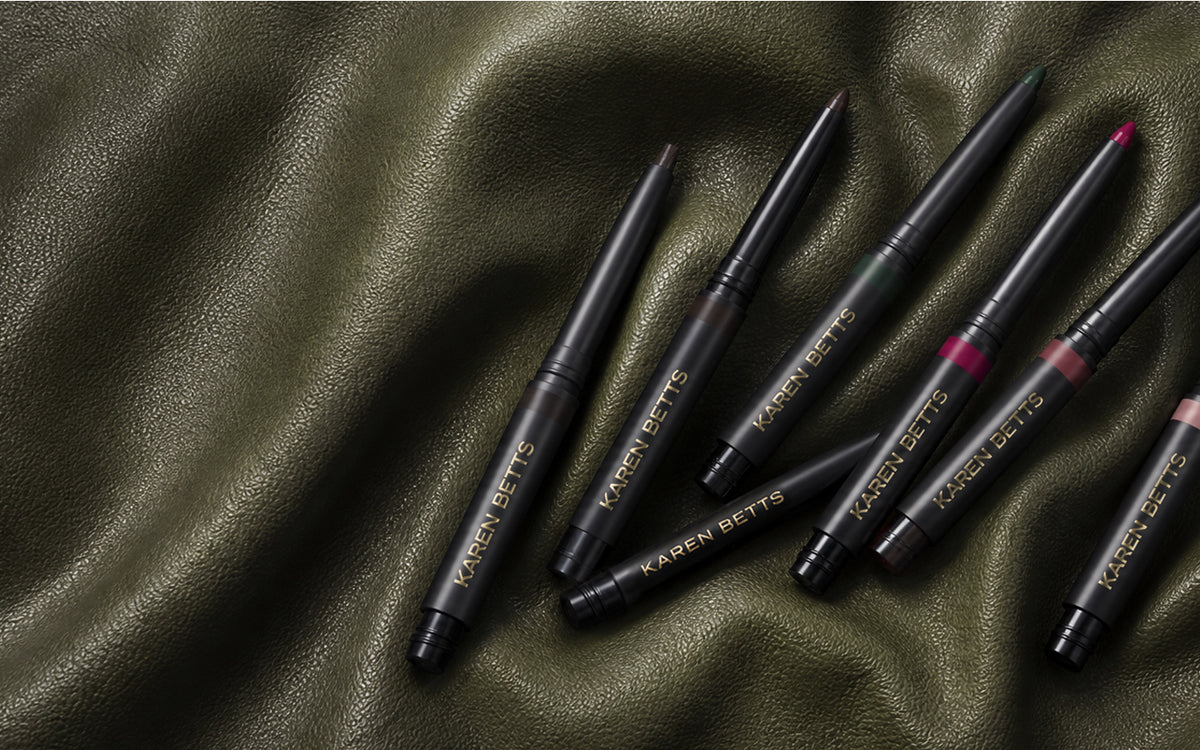 Karen Betts eye and lip pencil cartridges scattered across olive green leather
