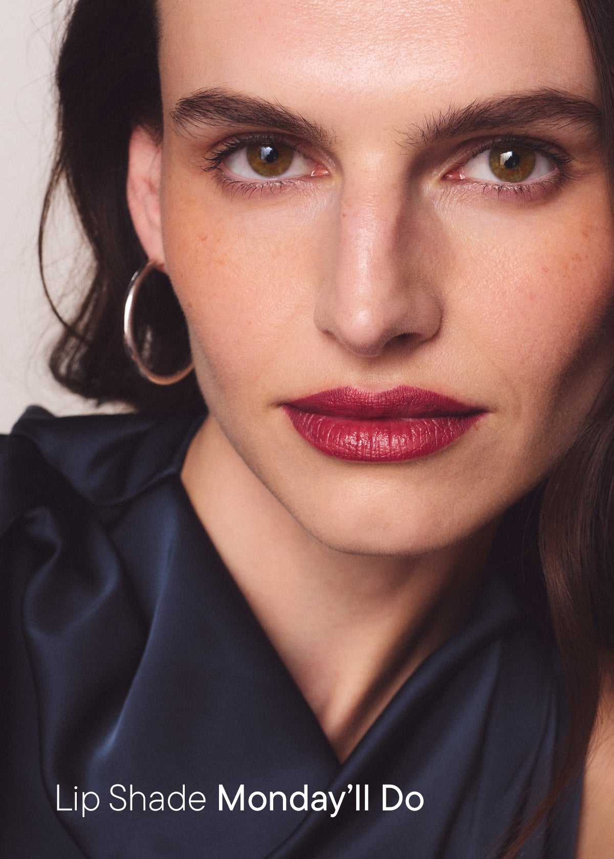 Woman wearing a deep berry lip, with the text "Lip Shade Monday'll Do"