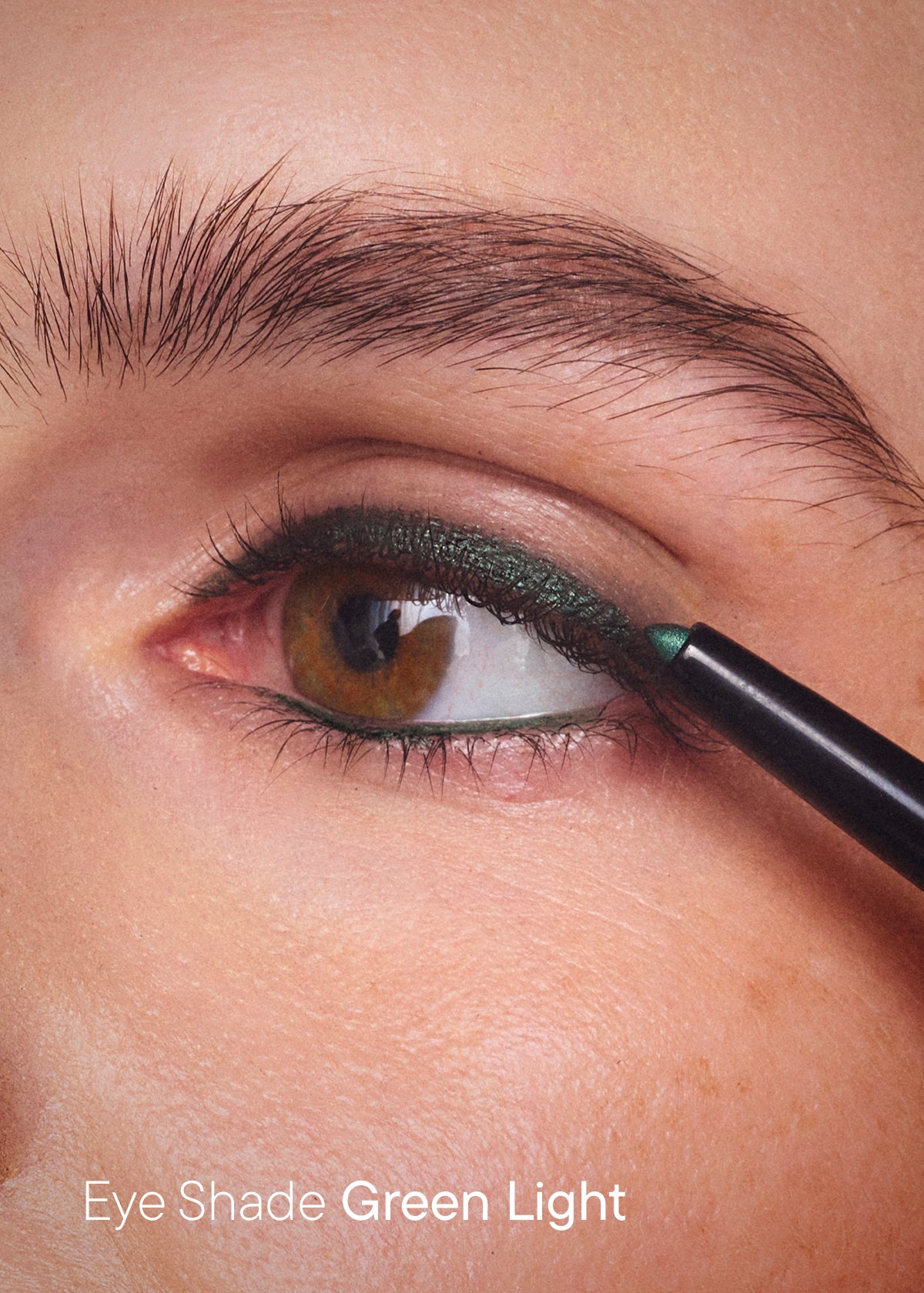 Green eyeliner being applied along the lash line, with the text "Eye Shade Green Light"