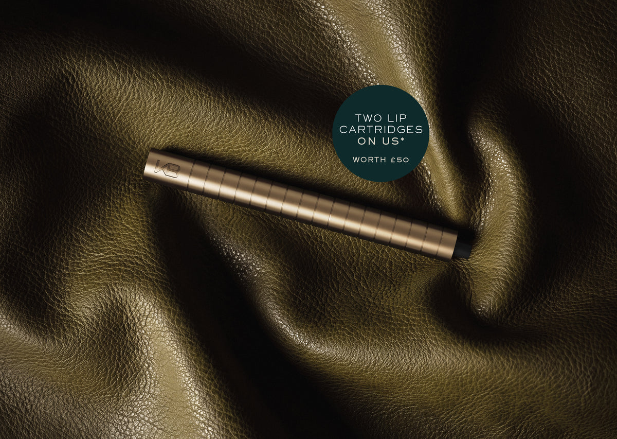 Karen Betts pen in Champagne on olive leather with a roundel reading "Two lip cartridges on us* – worth £50"