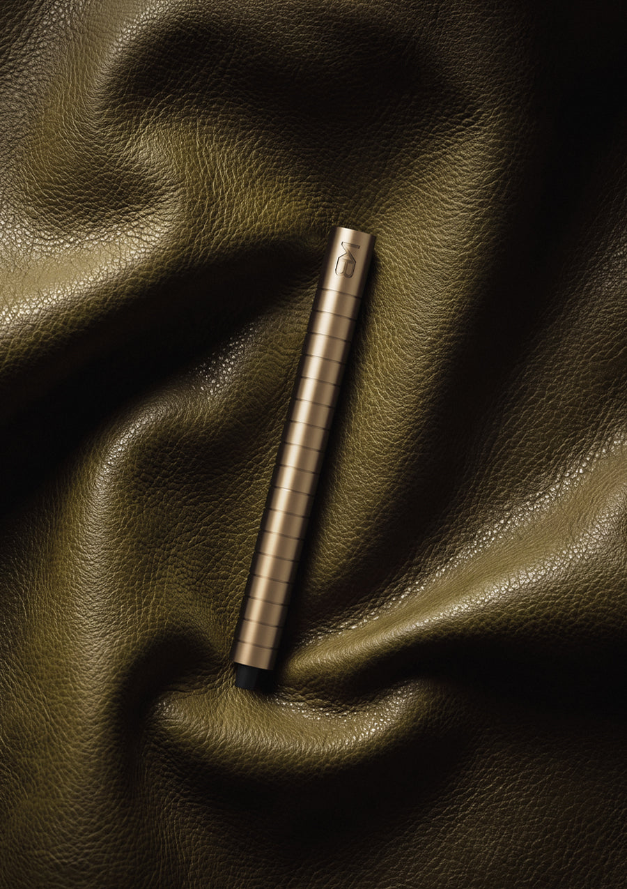 Karen Betts refillable pen in Champagne on folds of olive green leather