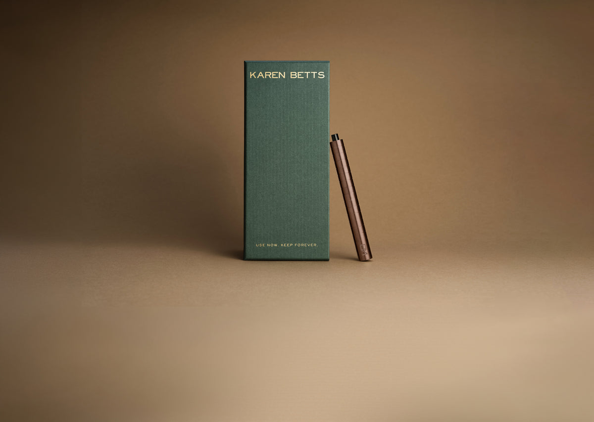Green Karen Betts pen box printed "Use now. Keep forever." with the Rosewood pen leaning against it